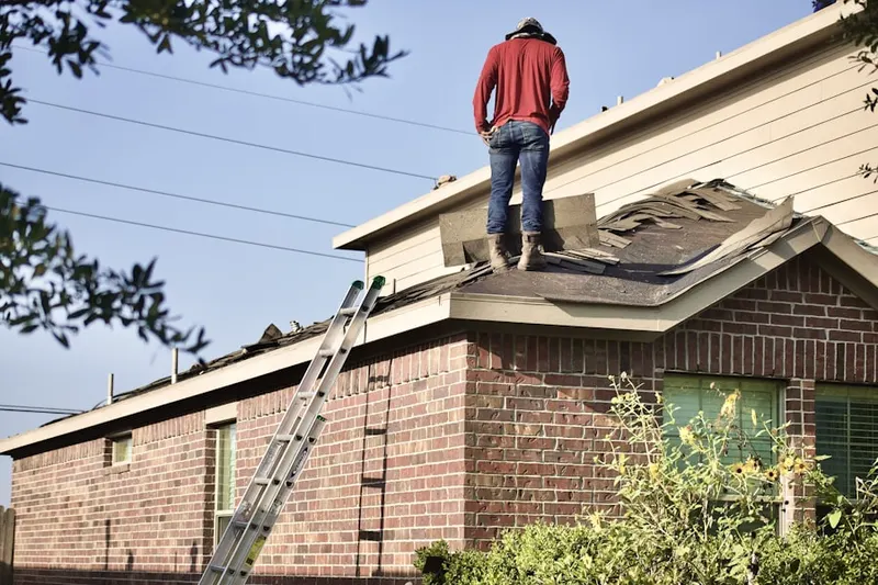 Professional roofer working on a residential roof in Heritage Hills